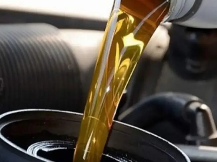 Amber fuel being poured into a drum