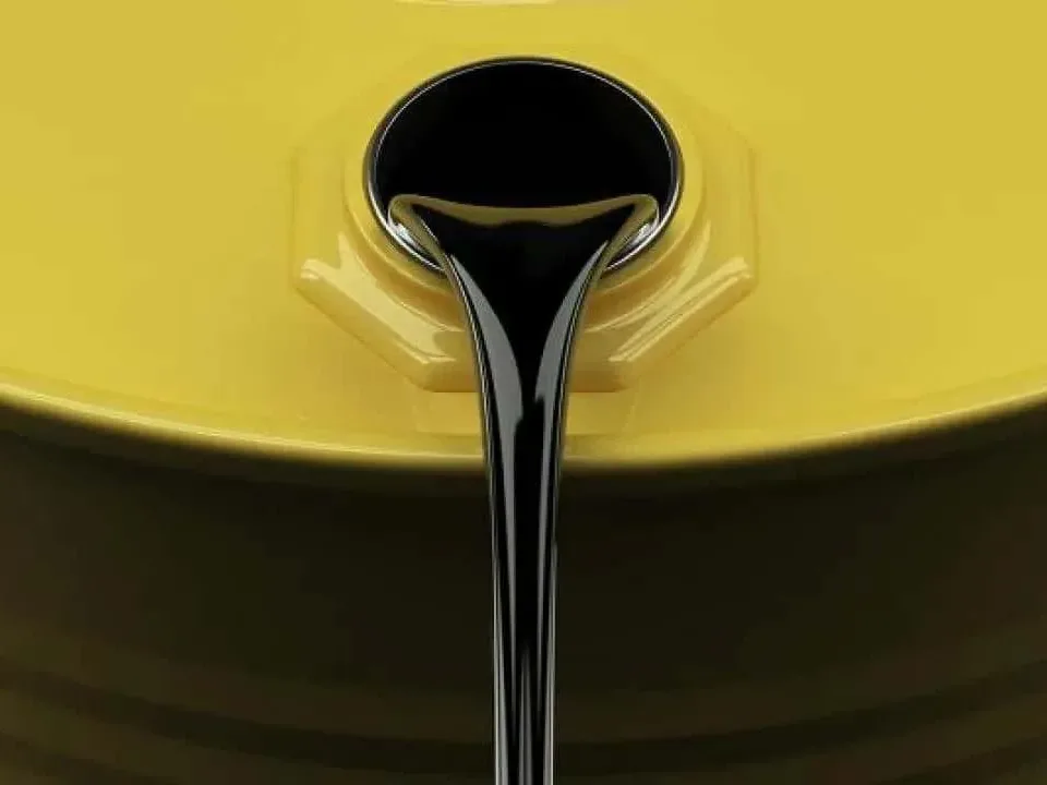 Heavy black fuel oil pouring from a yellow drum